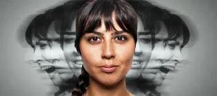 Woman looking at camera with black and white images of her face behind the main photo