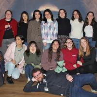 A group of students are smiling at the camera, having just succeeded at escaping an escape room together