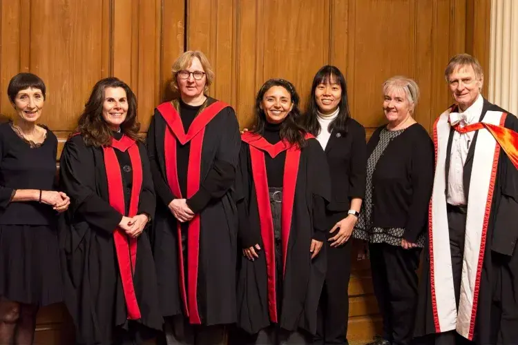 A group of our Nursing lecturers wearing their formal robes for graduation pose for a group photo together