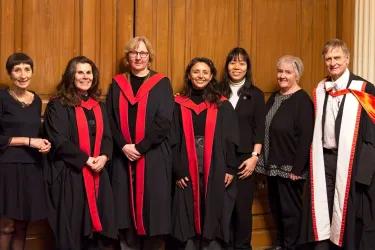 A group of our Nursing lecturers wearing their formal robes for graduation pose for a group photo together