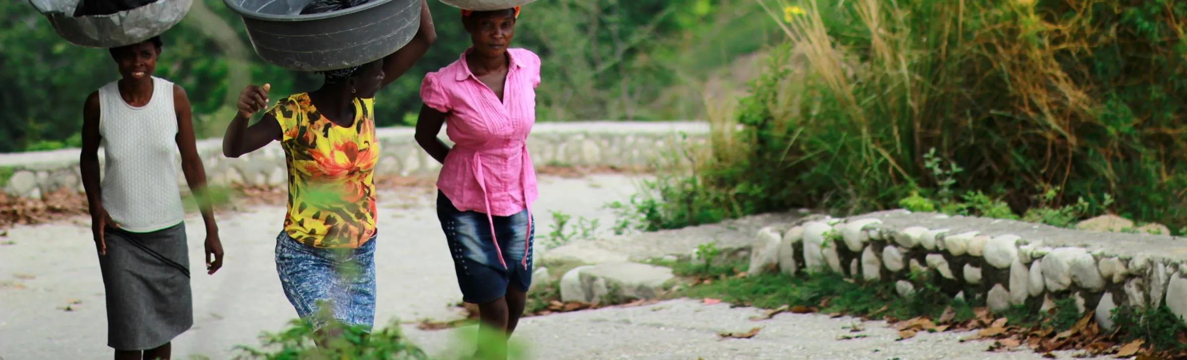 Women walking with bowls on their heads