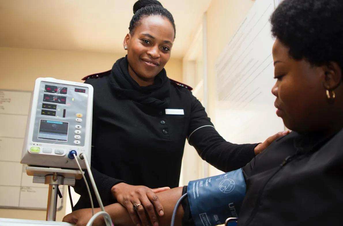 Female nurse checking the blood pressure of a patient