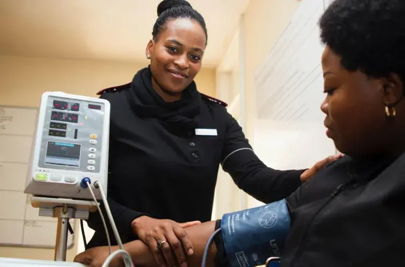 Female nurse checking the blood pressure of a patient