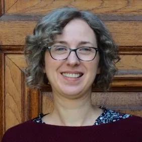 Anna is smiling warmly at the camera in this headshot image