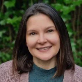Liz is smiling warmly at the camera in this headshot image