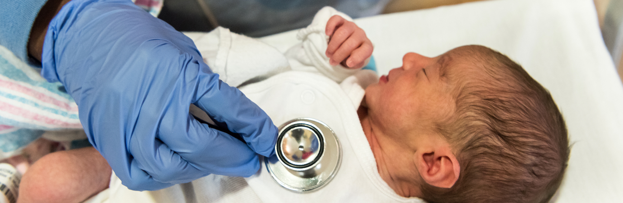 Newborn baby and stethoscope